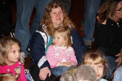 Parents and children watching the Santa in the Park show at Alley Park